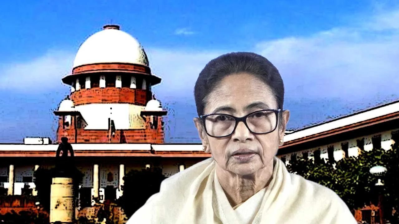 Portrait of an elderly woman with glasses and a light shawl, in front of a government building with a white dome under a blue sky.