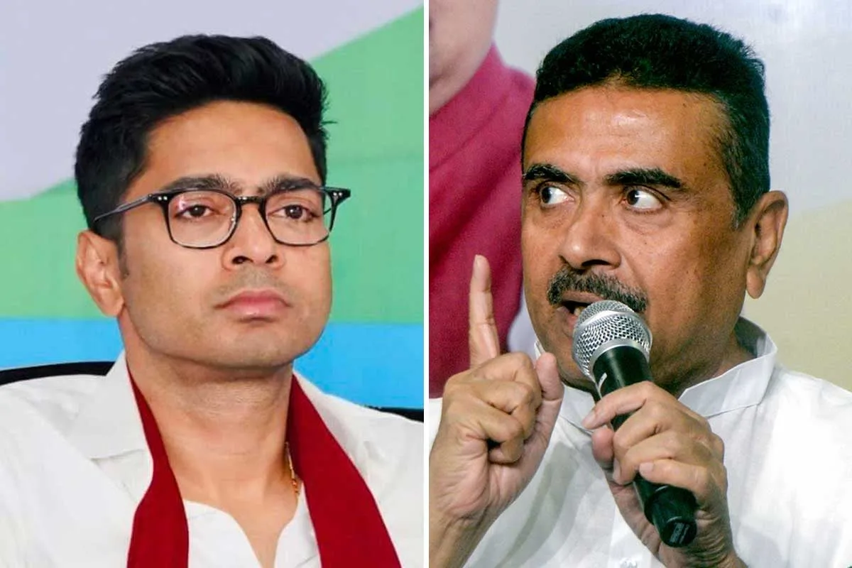 Two men in a split-frame: left man with glasses and a white coat with a red scarf, right man speaking into a microphone while gesturing with his finger.