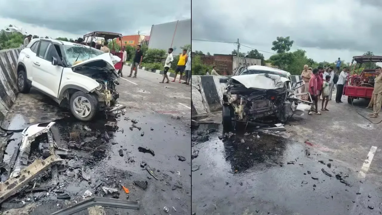 White SUV heavily damaged at a concrete barrier with debris and a wet, slick road; bystanders gather at the scene of a crash.